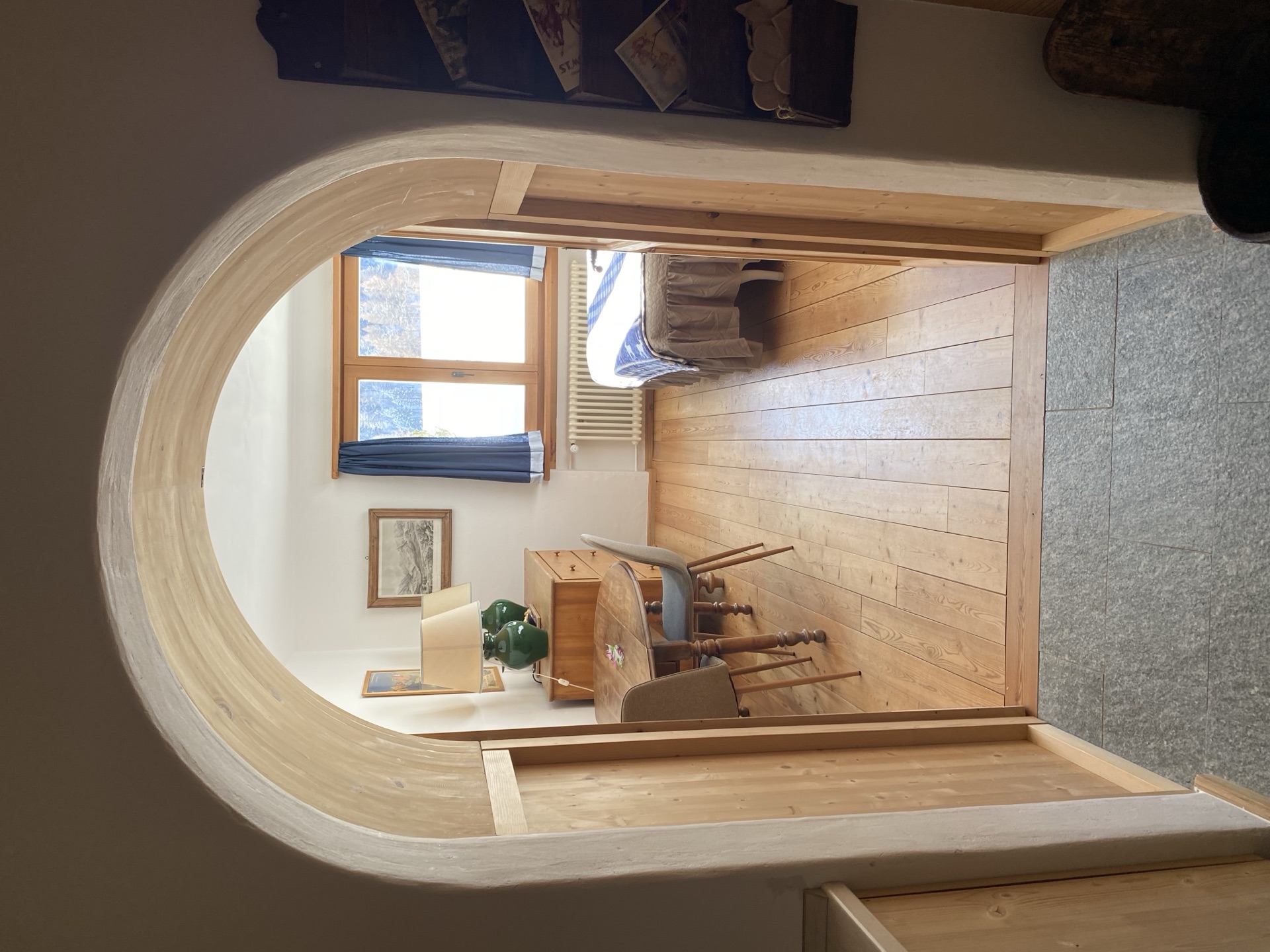 Cozy room through pine wood archway