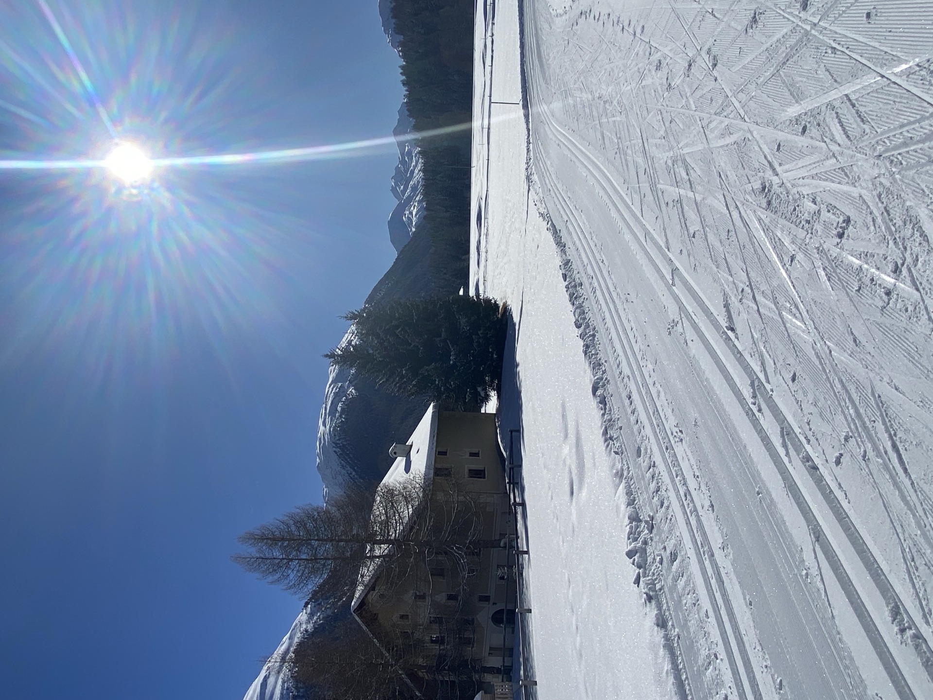 Snowy cross-country trail with Engadin mountains